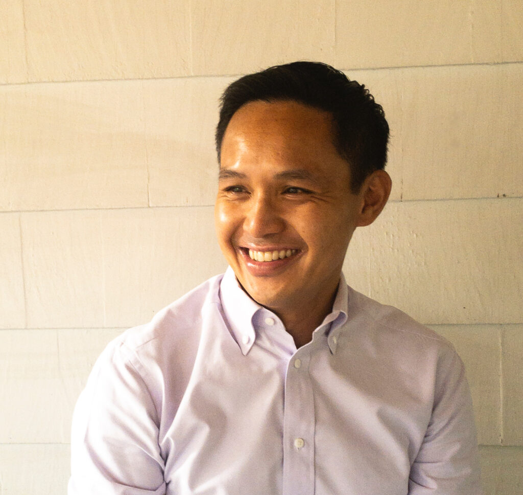 Dr. Orquiza smiling against a white background
